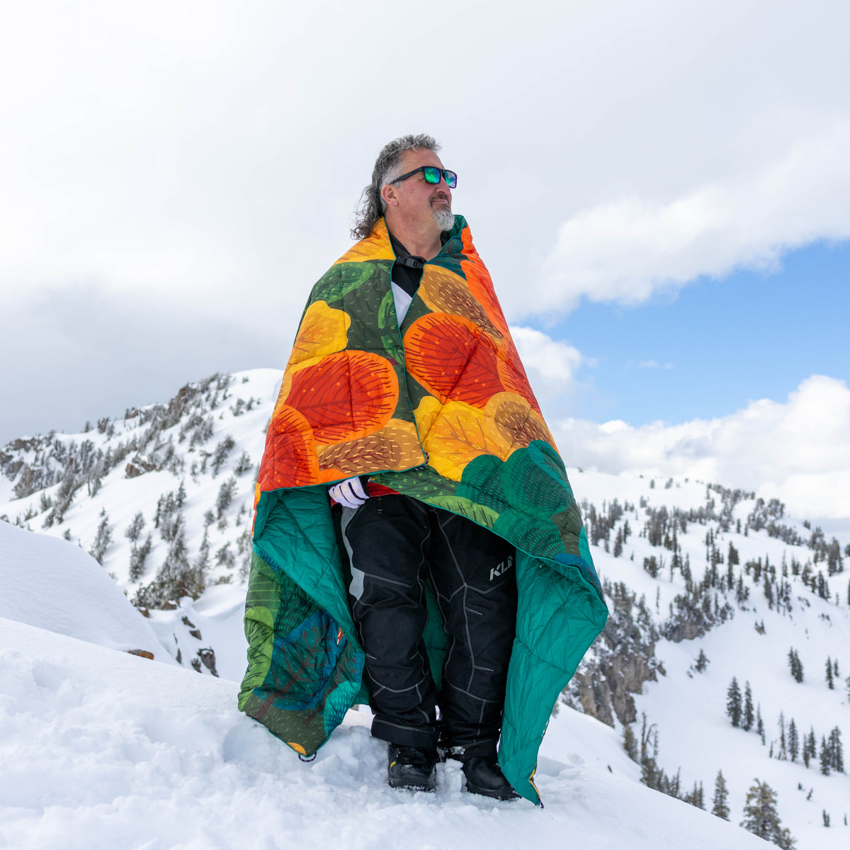 Kukün insulated puffy blanket on a snowy mountain adventure
