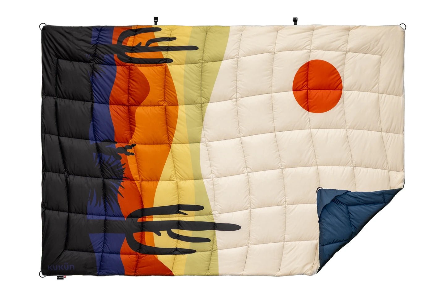 Unfolded Desert blanket with a front corner turned back to show its navy reverse.
